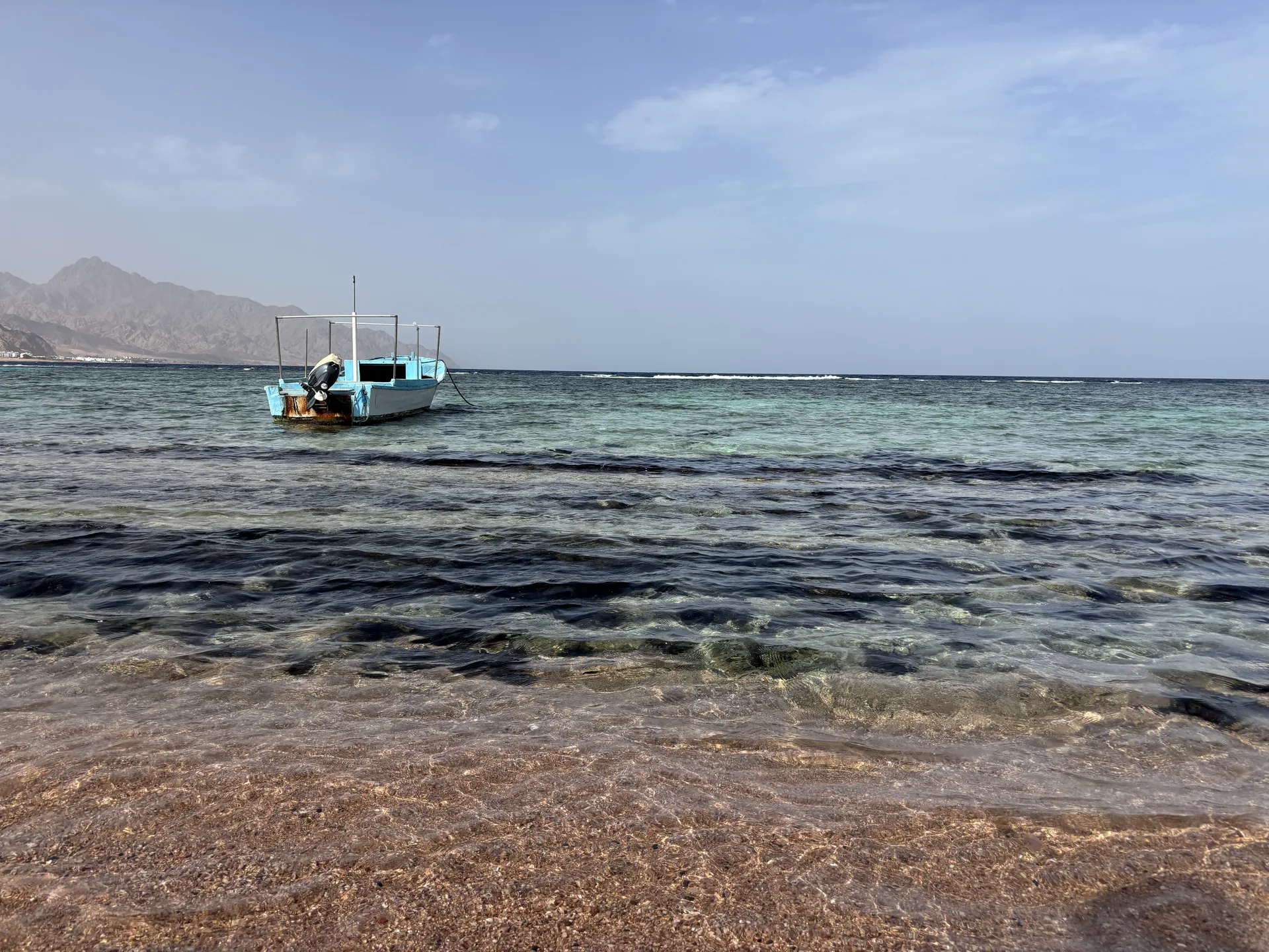 A fishing boat anchored in the still waters of Dahab